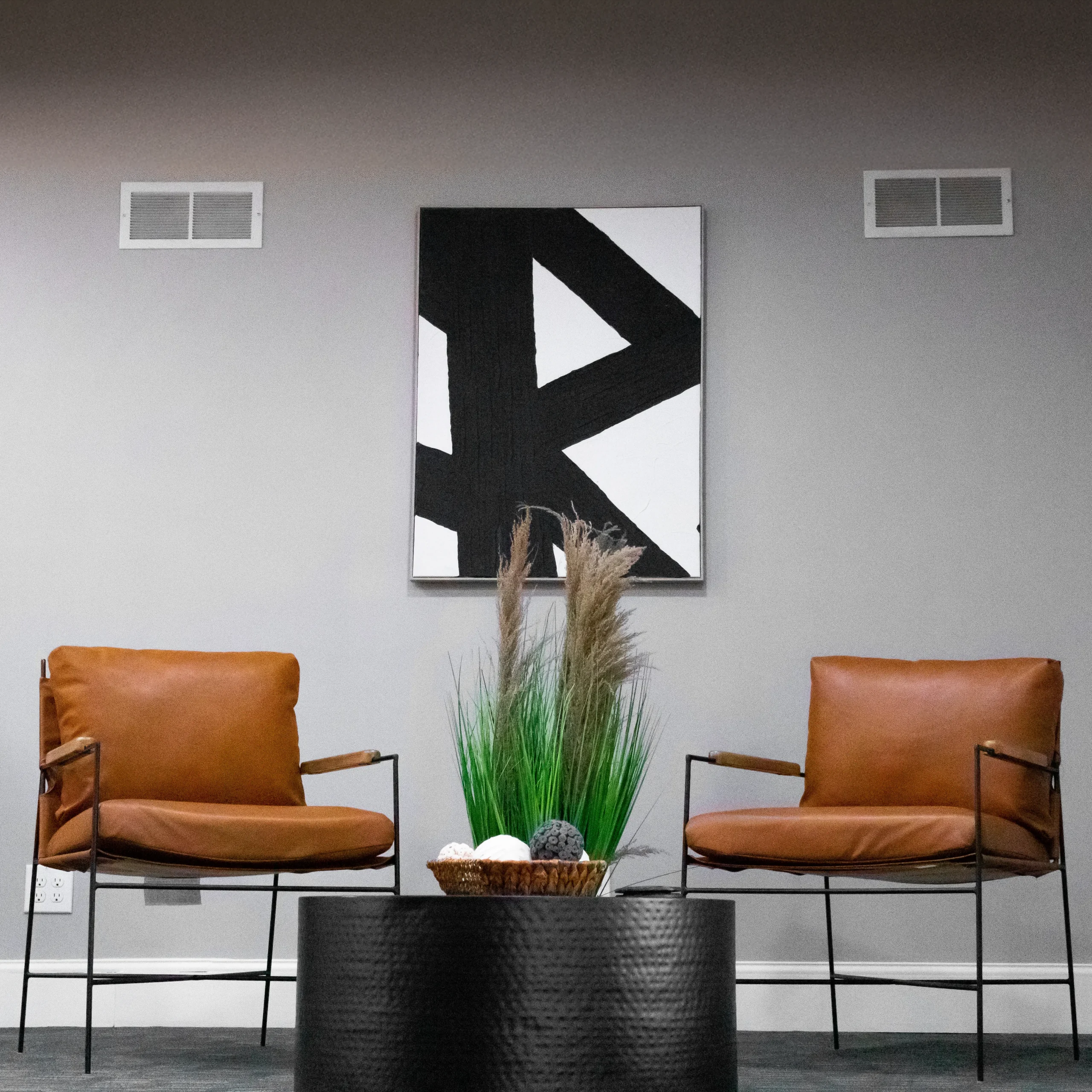 Two leather chairs in the common area at Akron Spaces