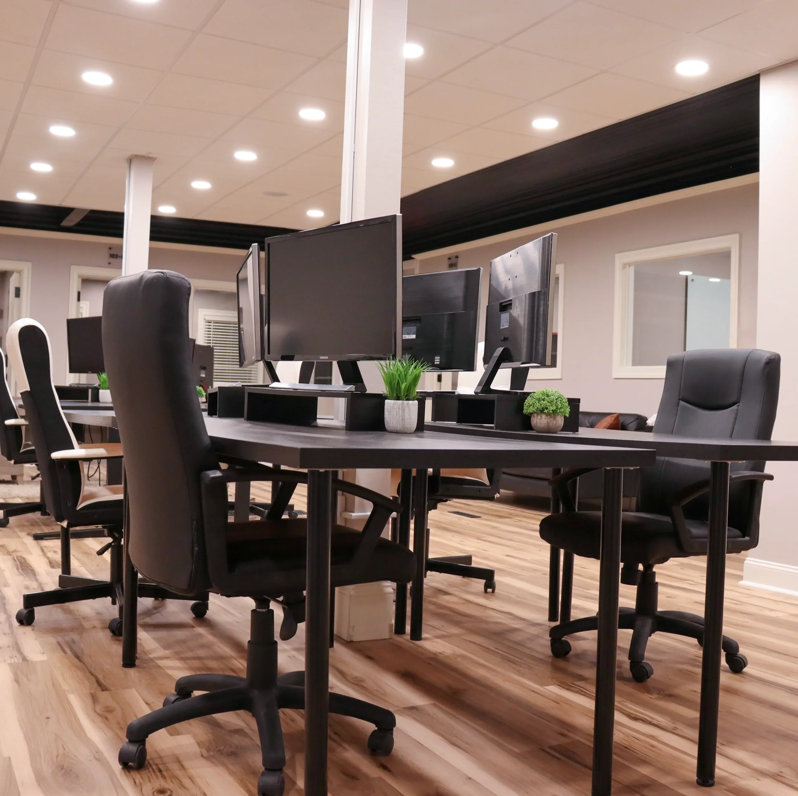 Desk setup in the coworking area at Akron Spaces featuring a clean, modern workspace