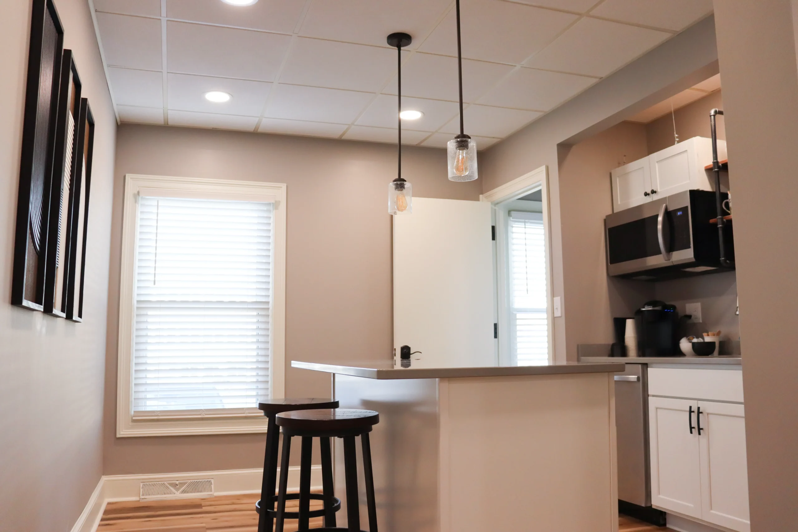 Kitchen in Suite 102 with an island and barstools for coworking and breaks