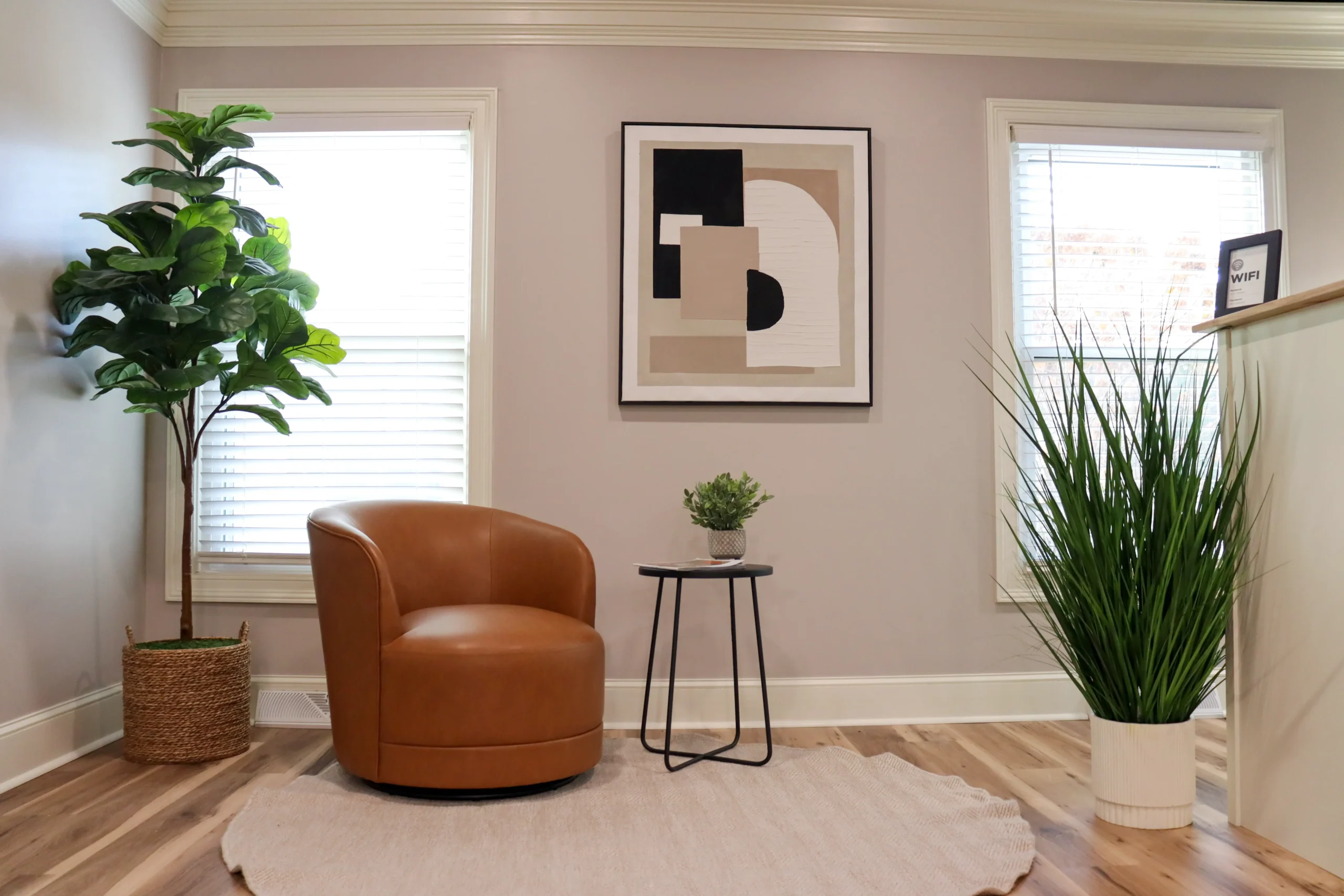 A comfy waiting area featuring a swivel chair and modern decorations