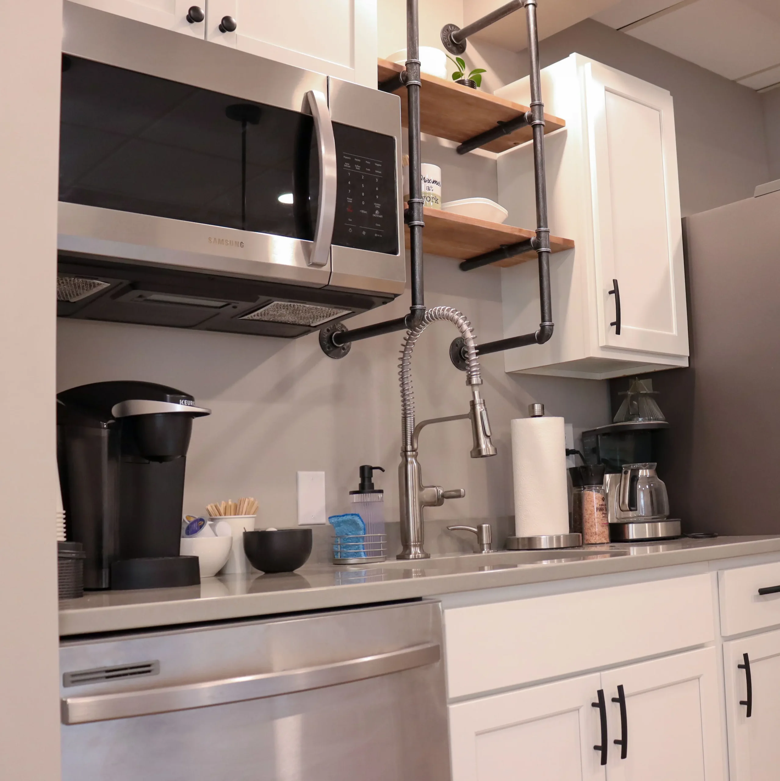 Kitchen amenities in Suite 102, including microwave, dishwasher, and coffee setup at Akron Spaces