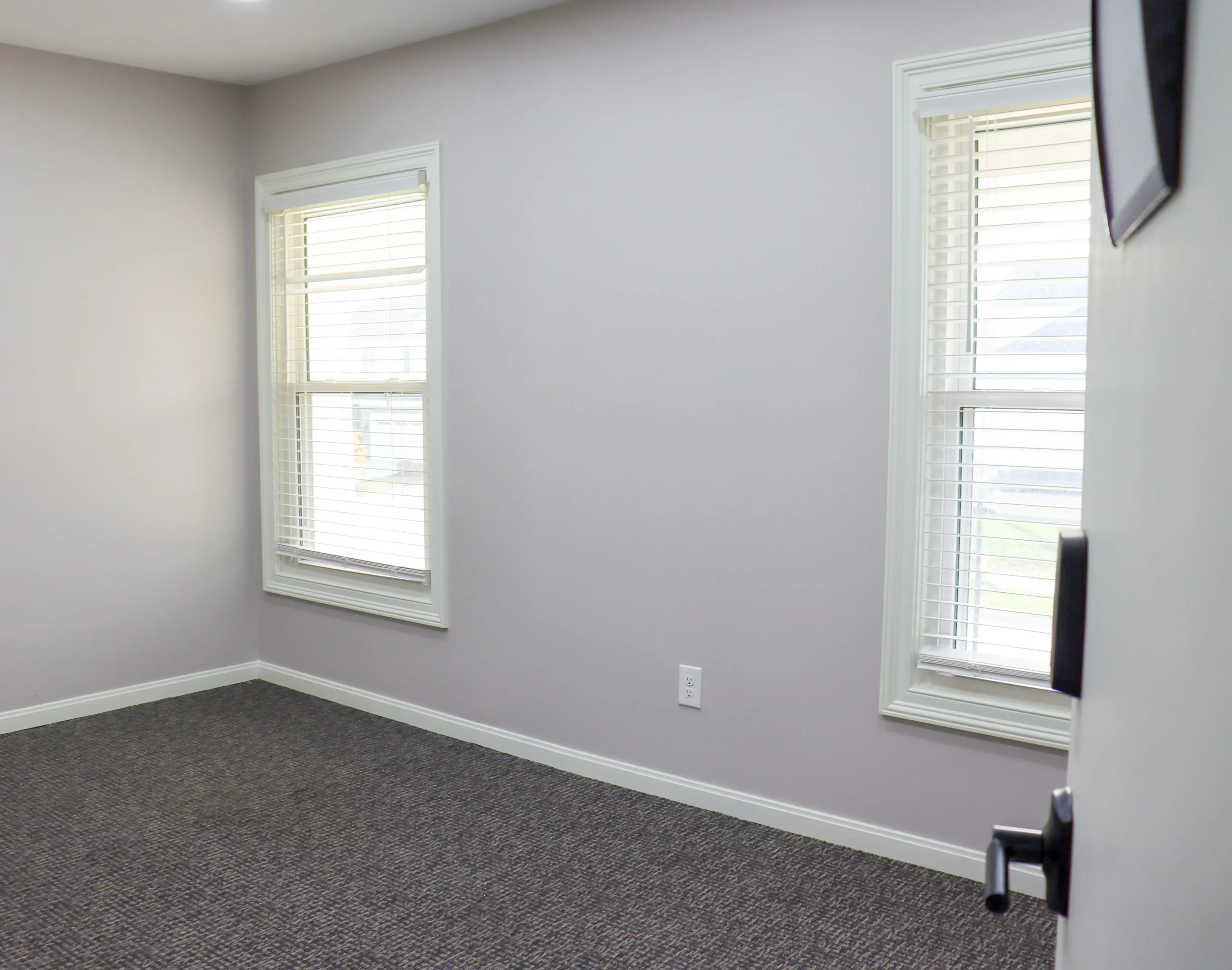 A spacious office space with two windows available for rent