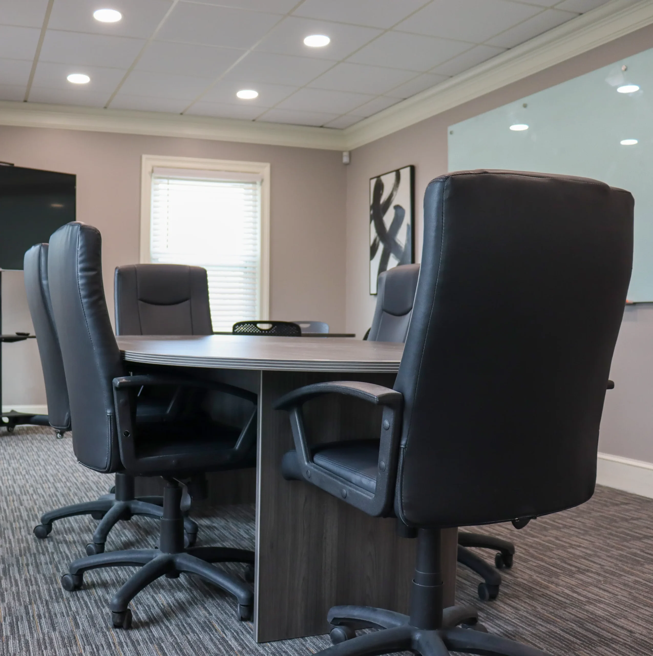 Meeting room with a conference table and six chairs.