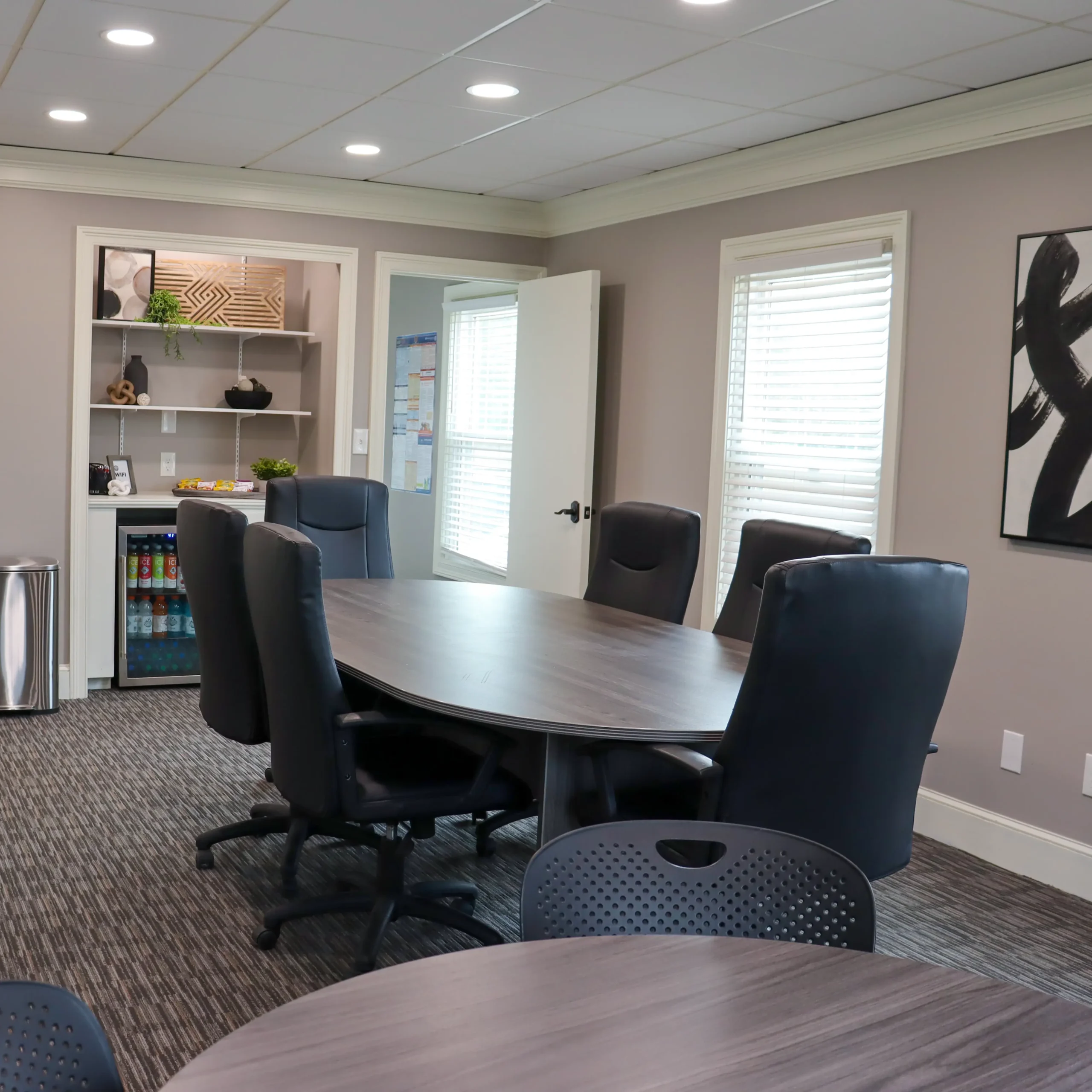 A modern meeting room for up to ten individuals.
